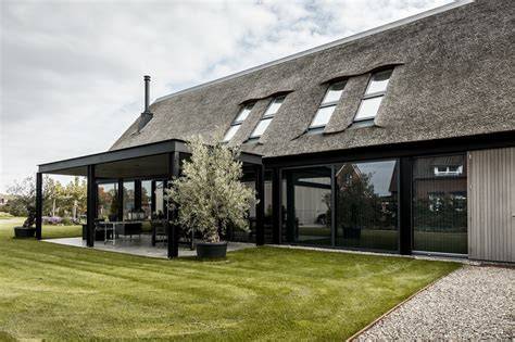 Afbeelding: Voorbeeld van een boerderij die buiten en binnen naadloos verbindt, met moderne afwerking én behoud van oude elementen.