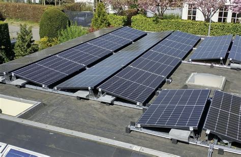 Voorbeeldfoto van een wit, plat dak met zonnepanelen.