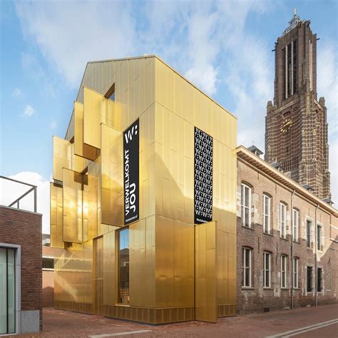 Gedetailleerde foto van de nieuwe, goudkleurige gevel van Museum W, die de verschillende bouwperiodes van het gebouw weerspiegelt.