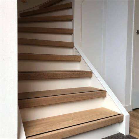 Voorbeeld van traprenovatie met witte stootborden en kleurcoördinatie