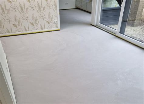 Detailopname van een zandcement vloer met zichtbare textuur