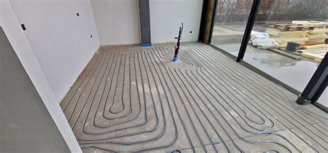 Schematische weergave van het infrezen van vloerverwarming in een betonnen vloer met freessleuven voor leidingen.
