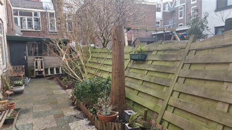 Foto van een omgewaaide schutting na een zware storm.