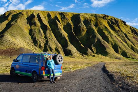 Een groep daktenten op een camping in IJsland, met op de achtergrond een dramatisch berglandschap.