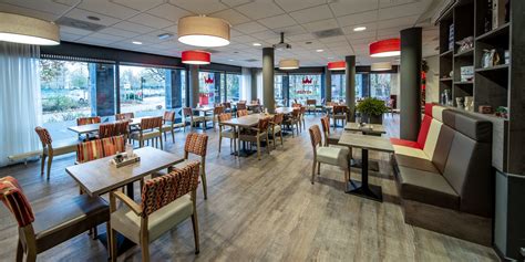 Logo Lunchroom De Keyser en foto van NAH-leerwerkers