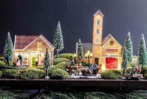 Illustratie van een compleet LuVille kerstdorp met verlichting en figurines